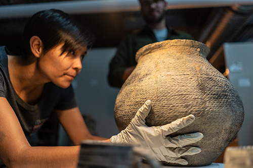 photo of someone holding a ceramic vase